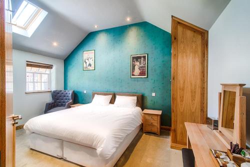 剑桥红狮宾馆的一间卧室设有一张床和蓝色的墙壁