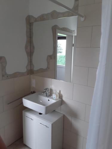 施莱登Pöhl am Nationalpark Eifel的白色的浴室设有水槽和镜子