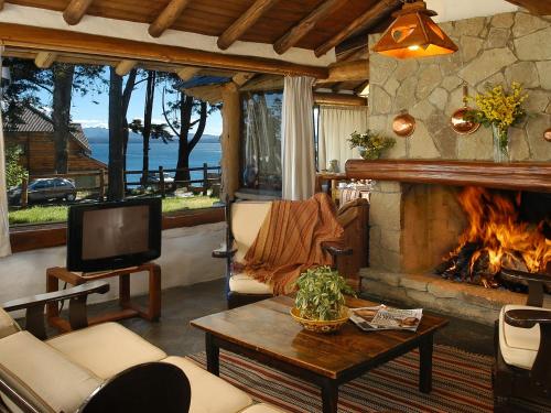 圣卡洛斯-德巴里洛切HTL La Malinka的客厅设有壁炉和电视。