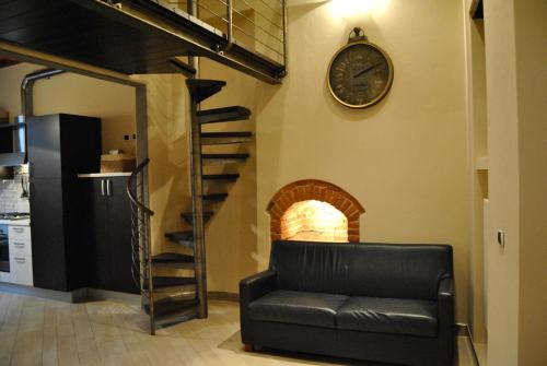 皮斯托亚Appartamento i Fabbri的客厅配有沙发和墙上的时钟