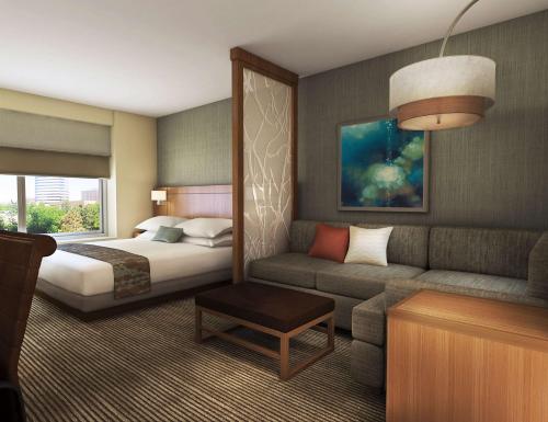 奥斯汀奥斯汀机场凯悦嘉轩酒店的酒店客房,配有床和沙发