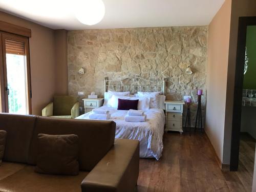 萨拉曼卡Casa rural Miranda的一间卧室配有一张床和一张沙发