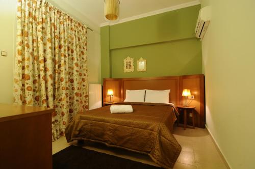 卡泰里尼公园酒店的一间卧室设有一张床和绿色的墙壁