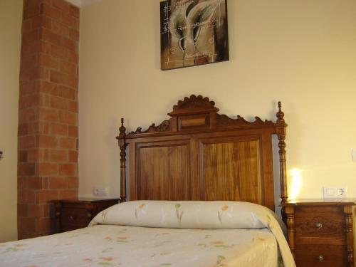 埃尔博斯克Casa La Vega的一间卧室配有一张带木制床头板的床