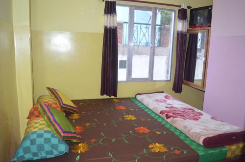 瓦拉纳西阿祖尔旅馆的窗户客房内的小床
