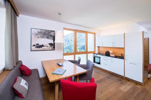 索内纳尔佩·纳斯费尔德阿尔卑斯露斯纳斯费尔德公寓的客厅以及带桌子和沙发的厨房。