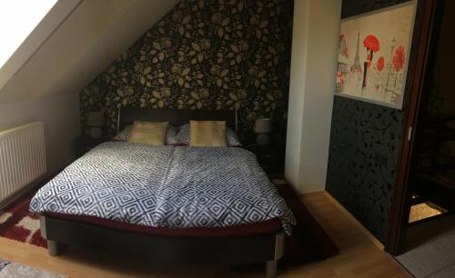 考波什堡Korona Apartman的一间卧室配有一张带黑白色棉被的床