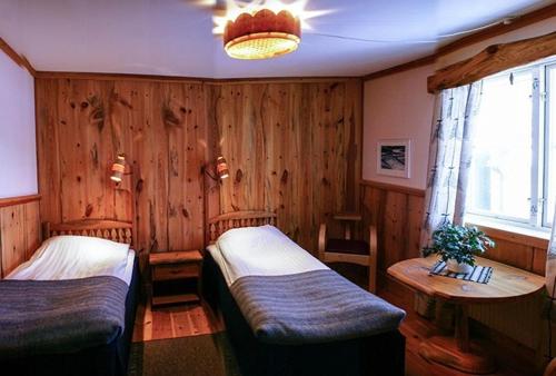 PersåsenSTF Hotel & Hostel Persåsen的一间卧室设有两张床、一张桌子和一个窗口
