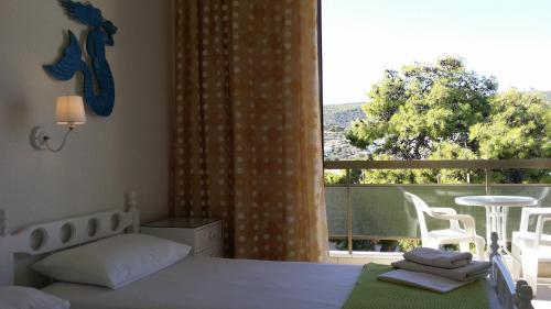 阿吉亚玛丽娜雷切尔酒店的一间卧室设有一张床和一个大窗户