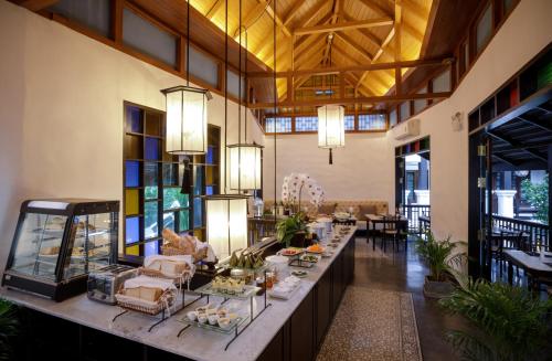 清迈泰阿卡拉-兰纳精品酒店-SHA Extra Plus的大房间,配有长桌和食物