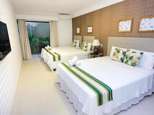 Hotel Premium Recanto da Passagem客房内的一张或多张床位