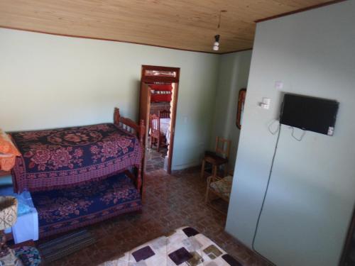 乌玛瓦卡El Churqui的客房设有一张床、一台冰箱和一台电视。