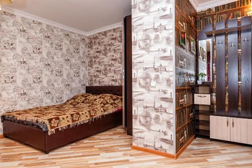 克麦罗沃квартира в центре, 50 Лет Октября 12的一间卧室配有一张床和壁纸
