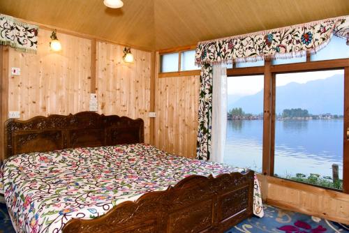 斯利那加White House Group Of Houseboats的一间卧室配有一张床,享有水景
