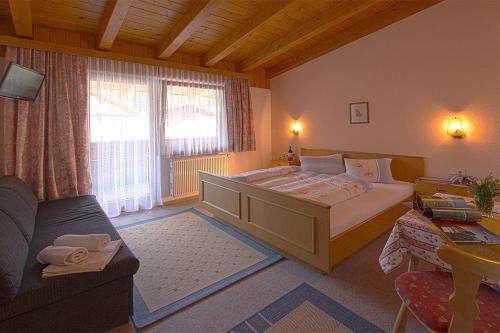 索尔登盖思福格兰斯汀膳食旅馆的一间卧室配有一张大床和一张沙发