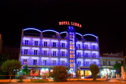 阿瑞达伊亚Lidra Hotel的建筑的侧面有蓝色的灯光