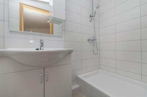 杜埃Apartment Neda的白色的浴室设有水槽和浴缸。