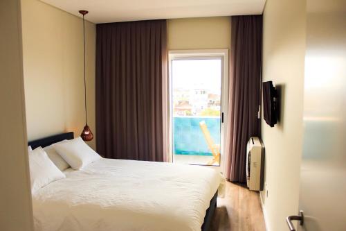 波尔图Apartamento da Lapa的一间卧室设有一张床和一个美景窗户。