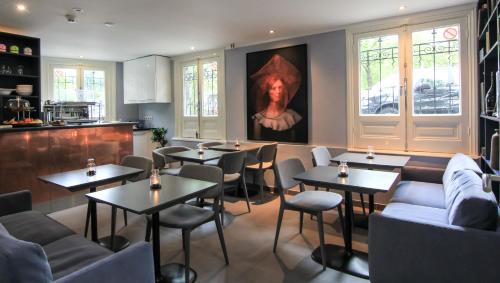 阿姆斯特丹377号旅馆的餐厅设有桌椅,墙上挂有绘画作品