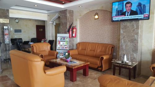 尼兹瓦尼兹瓦酒店公寓的一间设有皮革家具和电视的等候室