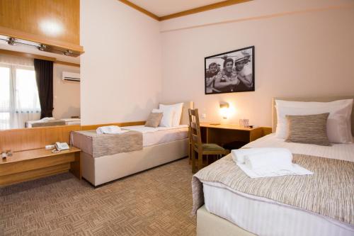 尼克希奇Hotel Yugoslavia的酒店客房配有两张床和一张书桌