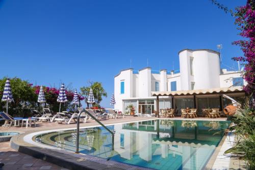 伊斯基亚罗蕾莱酒店的一个带桌椅的度假村游泳池
