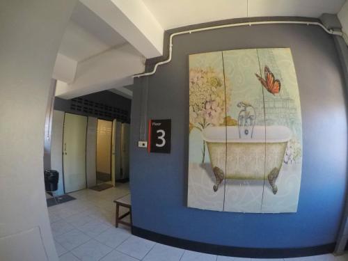 曼谷KC旅馆的墙上挂着水槽照片的走廊