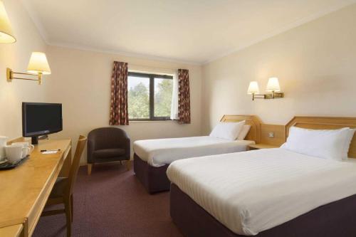 汤顿戴斯陶顿酒店的酒店客房配有两张床和一张书桌