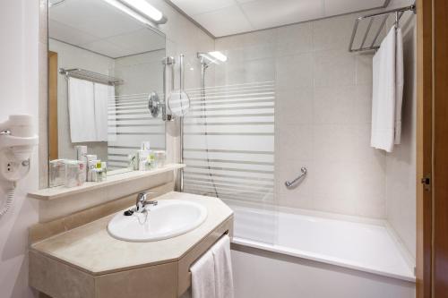 拉克鲁斯TRH Taoro Garden - Only Adults的白色的浴室设有水槽和淋浴。