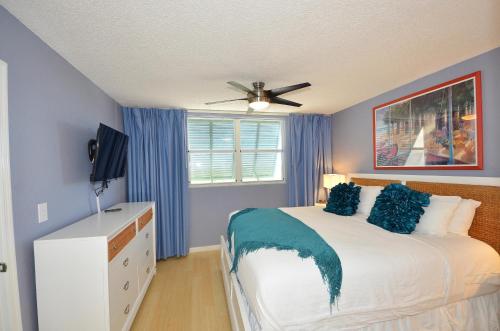 基韦斯特Sunrise Suites Cayo Coco Suite #208的一间卧室配有一张床和吊扇