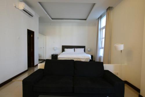 帝力拉姆劳酒店的客厅配有沙发和1张床