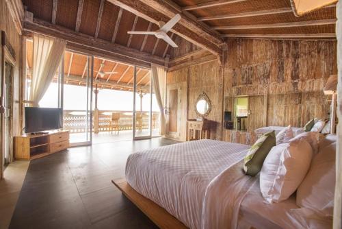 Klungkung贝拉基塔山脉度假村&Spa的一间卧室配有一张床和一台电视