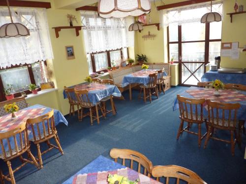 什平德莱鲁夫姆林Pension Borůvka的用餐室设有桌椅和窗户。