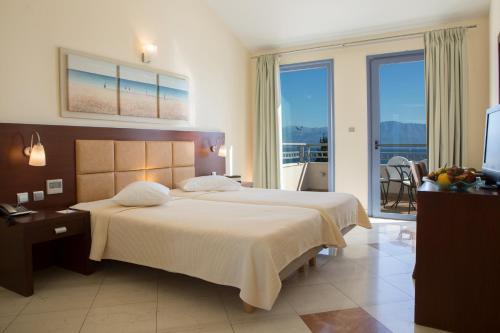 尼基亚娜波尔托加里尼海滨度假酒店&Spa的酒店客房设有两张床和一个阳台。