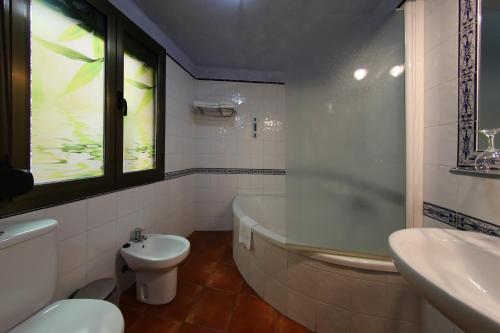 莱斯普卢加德夫兰科利欧塞弗兰克利乡村酒店的带浴缸、卫生间和盥洗盆的浴室
