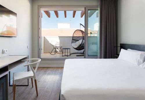 马德里B&B HOTEL Madrid Centro Puerta del Sol的一间卧室设有一张床,享有阳台的景色