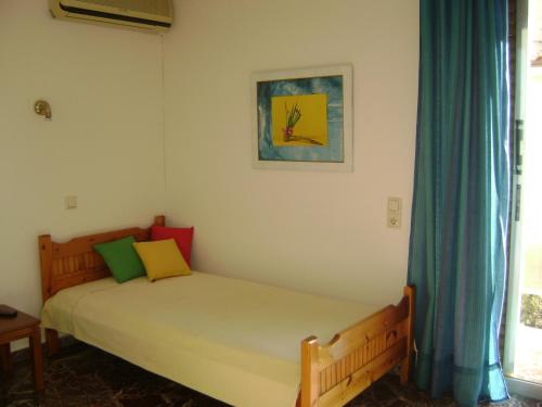 阿特米达Avra的卧室配有一张床,墙上挂有绘画作品