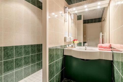 查内勒斯梅肯穆勒美食酒店的一间带水槽和镜子的浴室