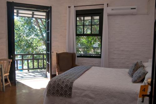 亚特兰蒂斯达Santoral Restaurante y Posada Pet Friendly的一间卧室设有一张床和一个滑动玻璃门