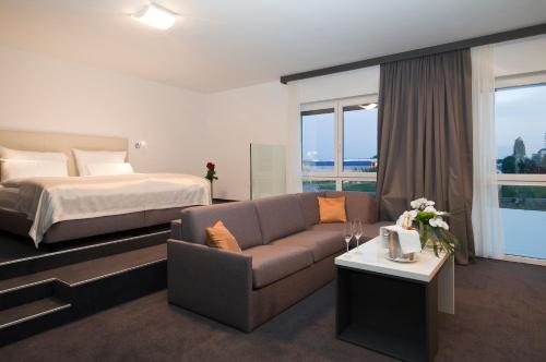 马里博尔马里博尔城市酒店的酒店客房配有床、沙发和桌子。