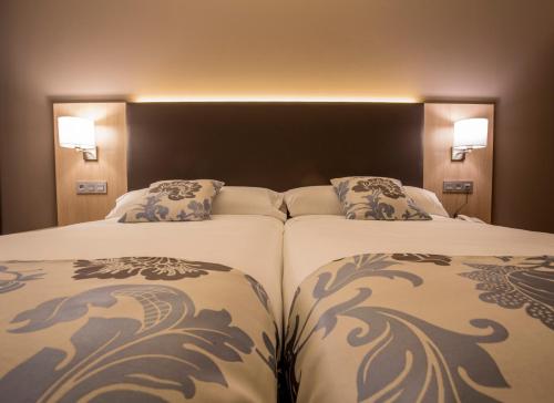 阿吉拉尔日波奥瓦伦丁酒店的两间相邻的床铺位于酒店客房内
