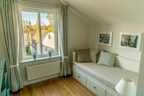 吕贝克Apartment Stadtblick的客厅的窗户前设有沙发