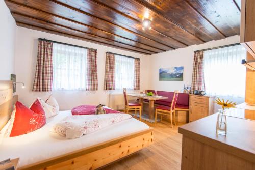 巴特霍夫加施泰因比奥霍夫莫拉古特旅馆的一间卧室设有一张床和一间用餐室