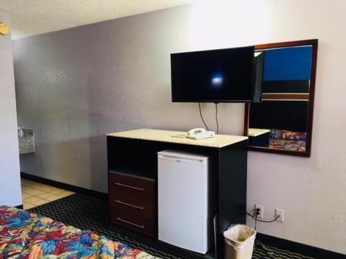 亚特兰大富尔顿汽车旅馆的客房设有一张床、一张书桌和一面镜子