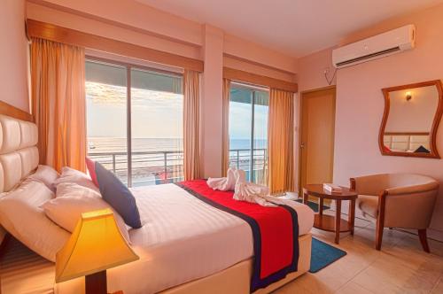 库克斯巴扎海皇冠酒店的一间卧室设有一张床,享有海景