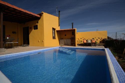 El Rosario芬卡拉马加德拉酒店的别墅前设有游泳池
