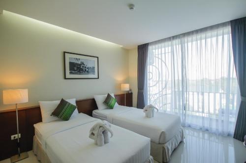 Baan Nilrath Hotel - SHA Extra Plus客房内的一张或多张床位