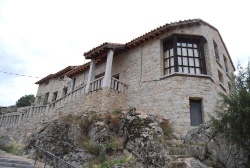 埃尔韦鲁埃科卡斯蒂略住宿酒店的一座古老的石头建筑,位于山上,设有楼梯