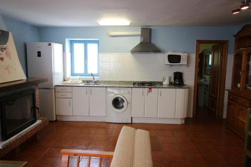 诺哈Casa Pedroso的厨房配有白色橱柜、洗衣机和烘干机