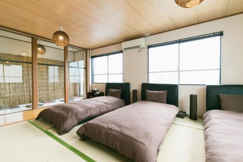 那霸冲绳那霸西方度假屋的带窗户的客房内的两张床